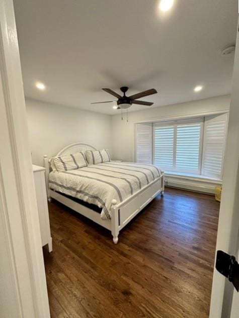 bedroom featuring ceiling fan and dark wood-type flooring