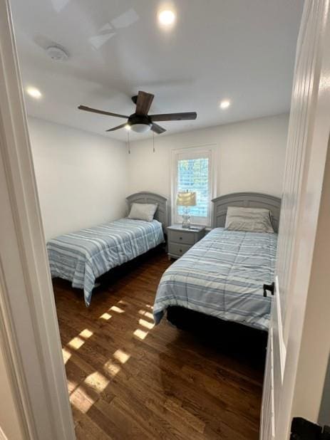 bedroom with ceiling fan and dark wood-type flooring