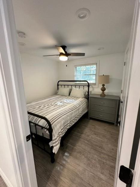 bedroom with ceiling fan and dark wood-type flooring