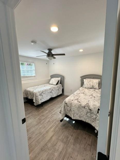 bedroom with ceiling fan and wood-type flooring