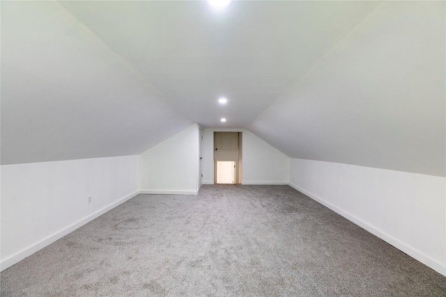 additional living space with carpet floors and lofted ceiling