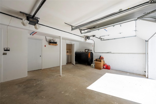 garage featuring washer / clothes dryer and a garage door opener