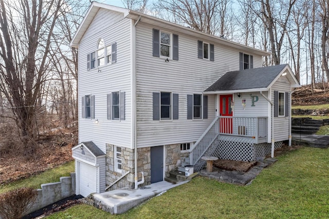 rear view of house with a garage and a lawn