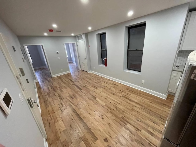 spare room with light hardwood / wood-style flooring