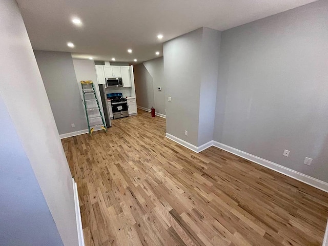 unfurnished living room with light wood-type flooring