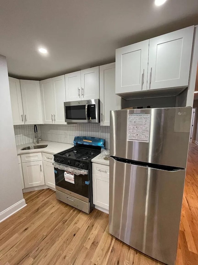 kitchen featuring sink, white cabinetry, and stainless steel appliances