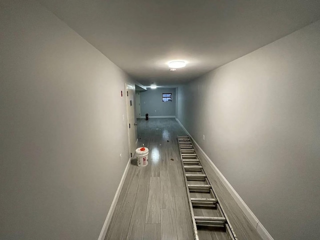 corridor with hardwood / wood-style floors