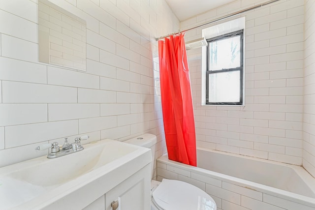 full bathroom with toilet, vanity, shower / bathtub combination with curtain, and tile walls