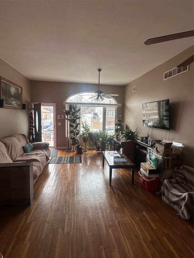 living area with ceiling fan, wood finished floors, and visible vents