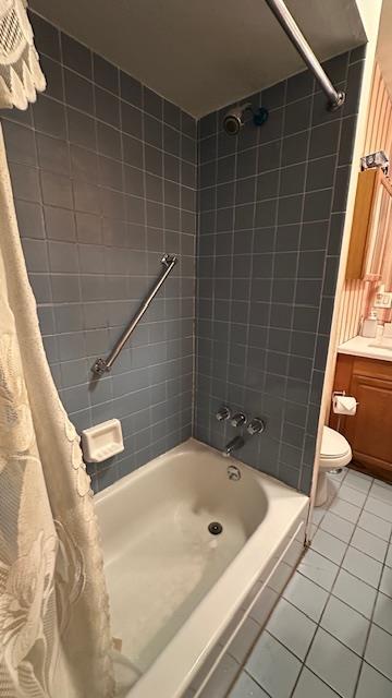 bathroom featuring tile patterned flooring, shower / bath combination with curtain, and toilet