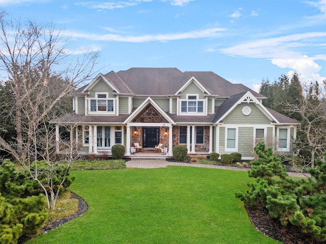 view of front of house with a front yard and covered porch