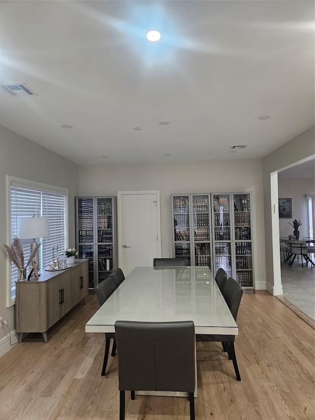 dining space with light hardwood / wood-style floors