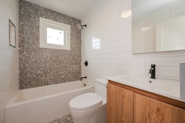 full bathroom with vanity, backsplash, tiled shower / bath combo, toilet, and tile walls