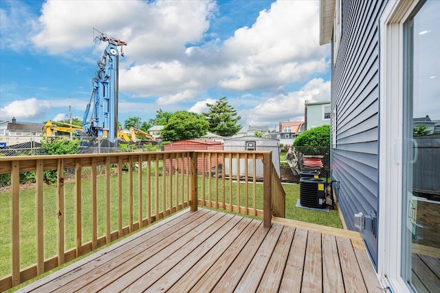 wooden terrace with central AC unit and a yard