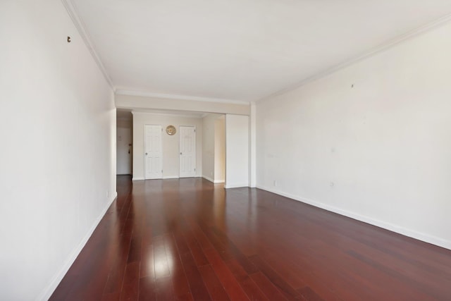 unfurnished room with dark wood-type flooring and ornamental molding