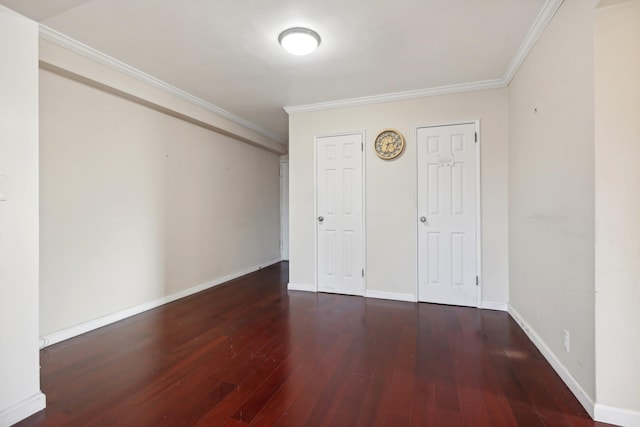 unfurnished bedroom with dark hardwood / wood-style flooring and ornamental molding