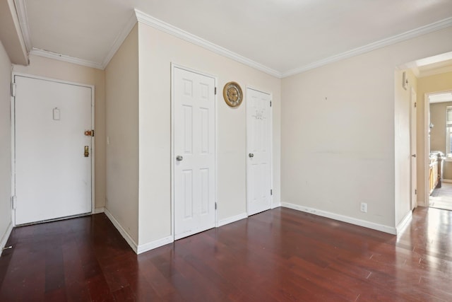 entryway with dark hardwood / wood-style floors and crown molding