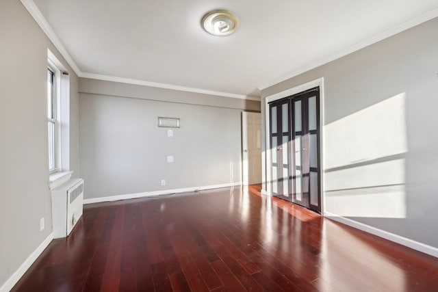 unfurnished room featuring ornamental molding, a healthy amount of sunlight, and wood-type flooring