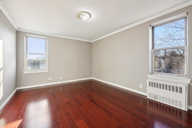 empty room with dark hardwood / wood-style flooring, radiator heating unit, and ornamental molding