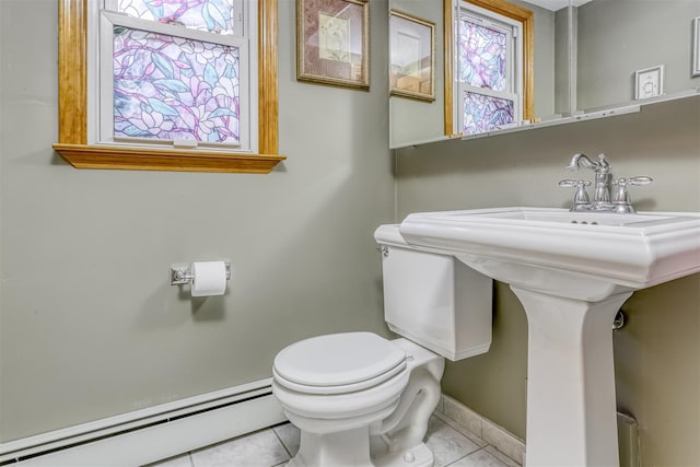 bathroom featuring baseboard heating and toilet