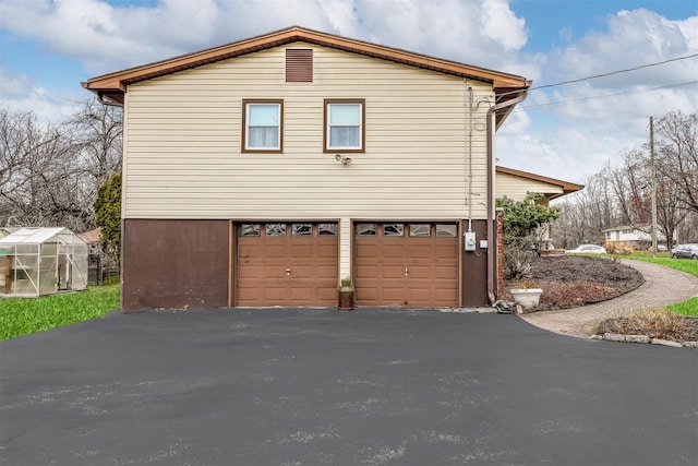 view of home's exterior featuring a garage and an outdoor structure