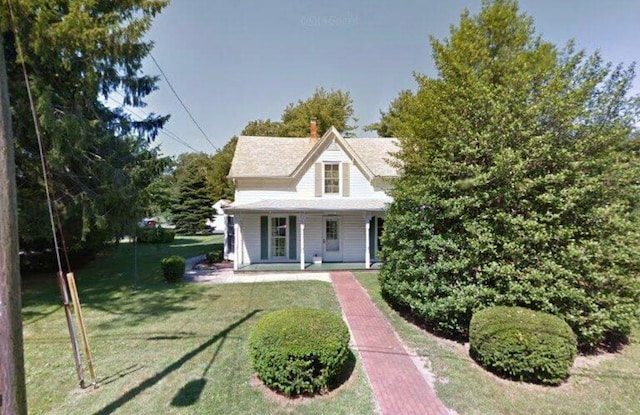 view of front facade with covered porch and a front lawn