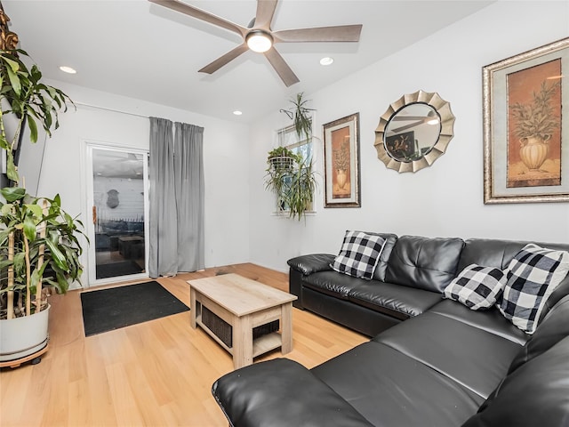 living room featuring hardwood / wood-style flooring and ceiling fan