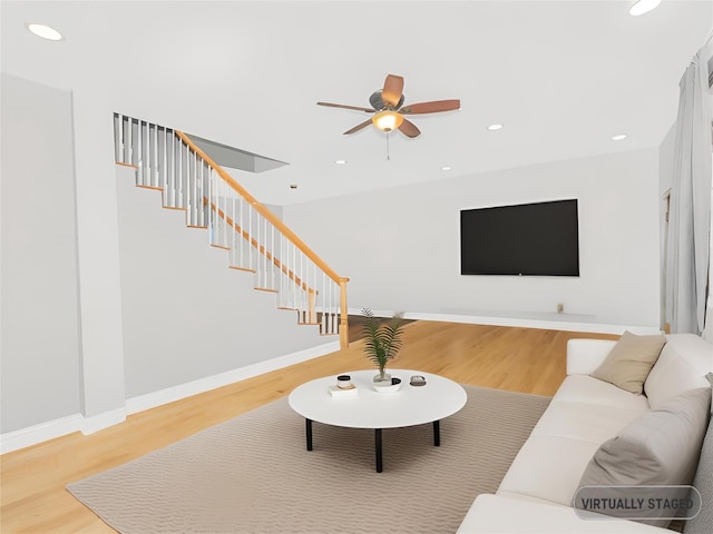 living room with hardwood / wood-style flooring and ceiling fan