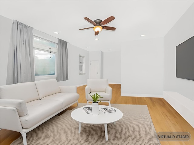 living room with hardwood / wood-style floors and ceiling fan