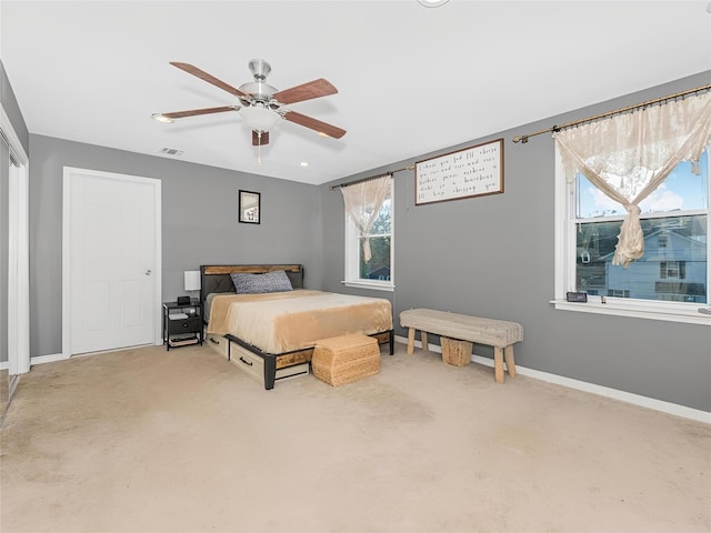 bedroom with carpet flooring, multiple windows, and ceiling fan