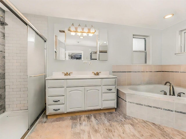 bathroom featuring vanity, hardwood / wood-style flooring, and separate shower and tub