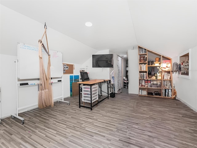 interior space with hardwood / wood-style flooring and vaulted ceiling