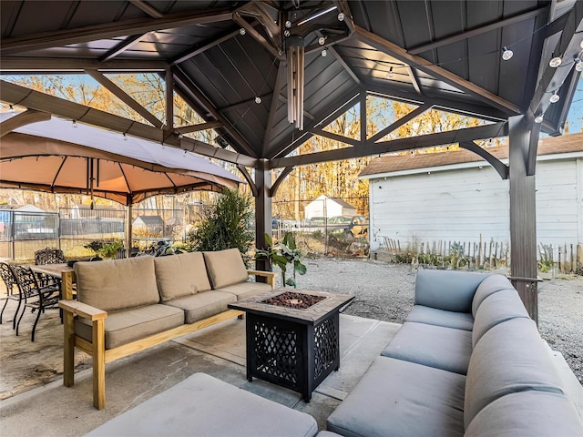 view of patio with a gazebo and an outdoor living space with a fire pit