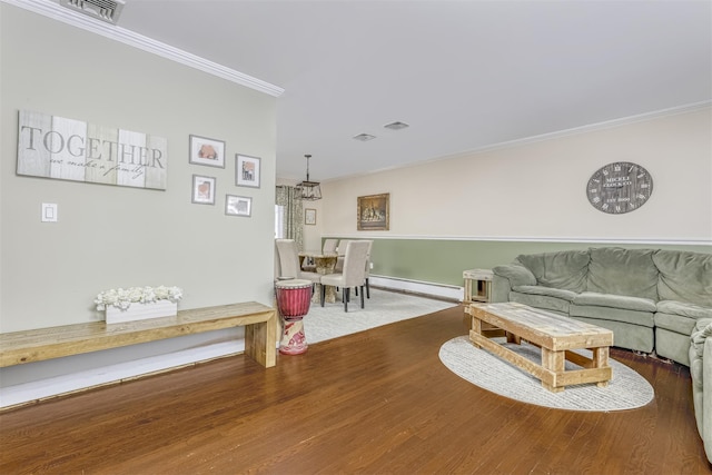 living room with a baseboard radiator, hardwood / wood-style flooring, and crown molding