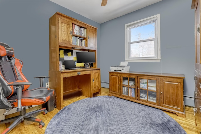 office area featuring light wood-type flooring, ceiling fan, and a baseboard heating unit