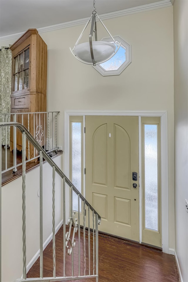 foyer featuring dark hardwood / wood-style flooring and crown molding