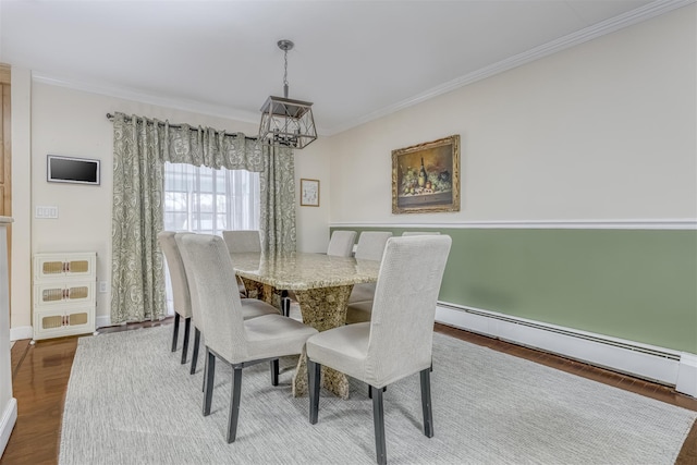 dining area with a baseboard radiator, ornamental molding, an inviting chandelier, and wood-type flooring