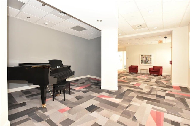 misc room with carpet floors and a paneled ceiling