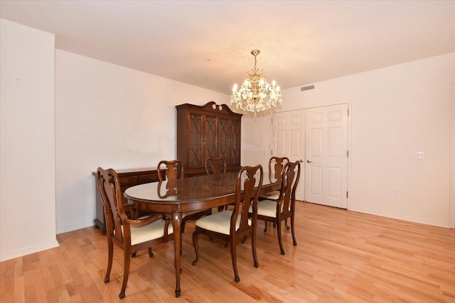 dining room featuring a chandelier and light hardwood / wood-style floors