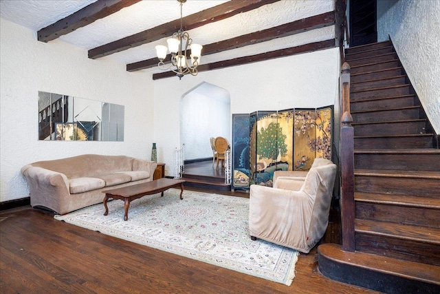 living room featuring beam ceiling, a chandelier, and dark hardwood / wood-style floors