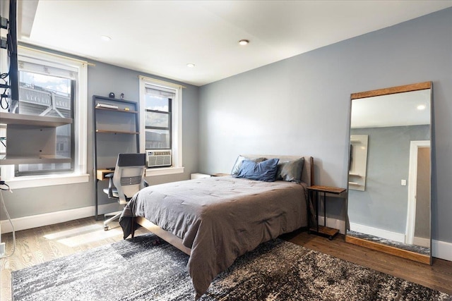 bedroom with cooling unit and dark wood-type flooring