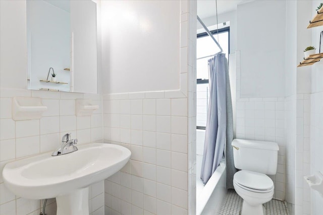 full bathroom with shower / bath combo with shower curtain, sink, tile walls, tile patterned flooring, and toilet