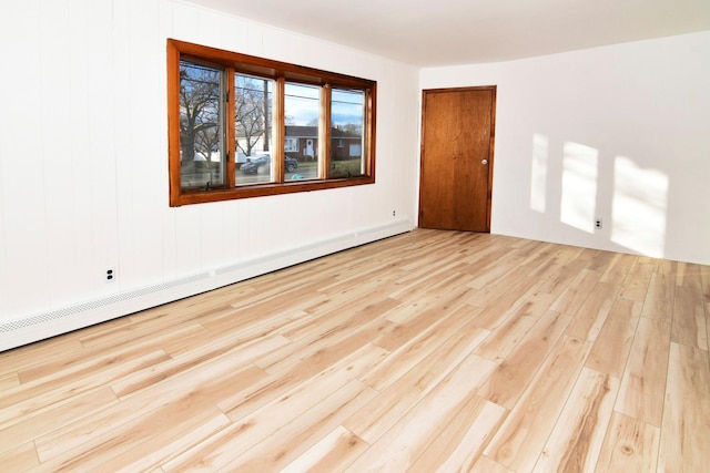 spare room featuring light hardwood / wood-style flooring and baseboard heating