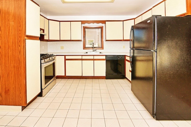 kitchen with black appliances, white cabinets, light tile patterned floors, and sink