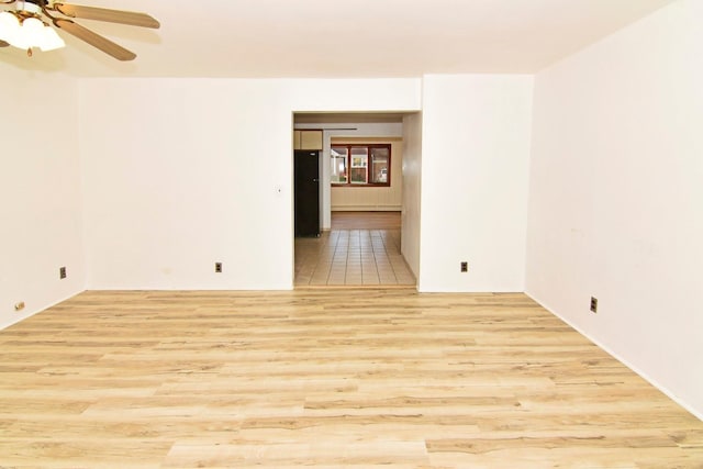 spare room featuring ceiling fan and light wood-type flooring