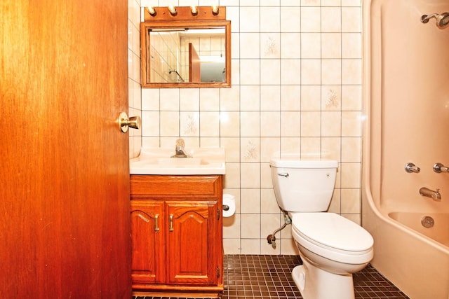 full bathroom featuring vanity, bathtub / shower combination, tile patterned flooring, toilet, and tile walls