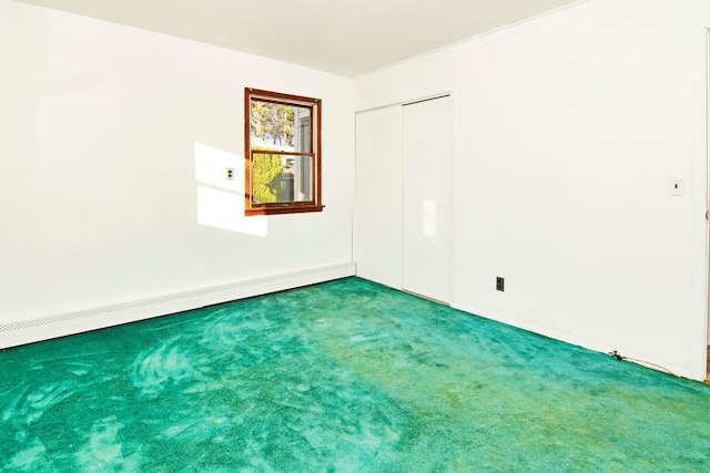 carpeted spare room featuring a baseboard radiator