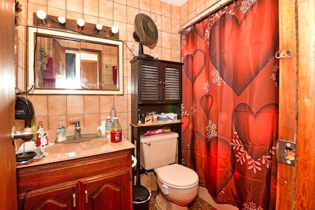 bathroom with vanity, toilet, tile walls, and vaulted ceiling