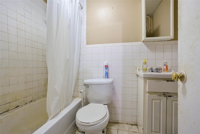 full bathroom with shower / bath combination with curtain, toilet, tile walls, and vanity