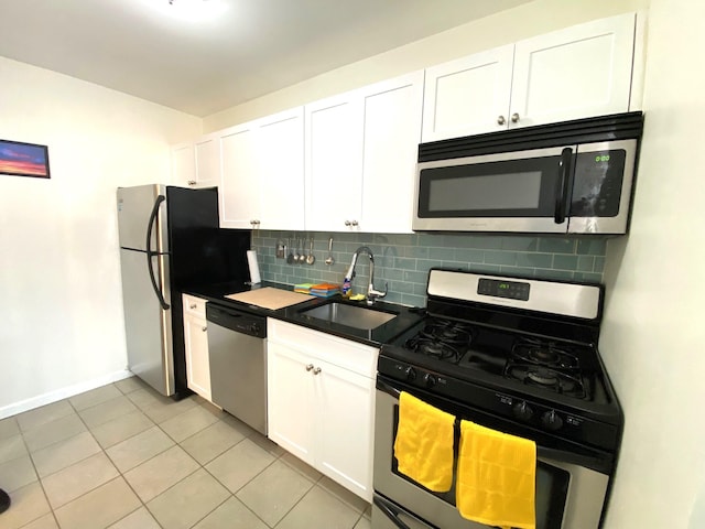 kitchen featuring white cabinets, light tile patterned flooring, sink, and stainless steel appliances